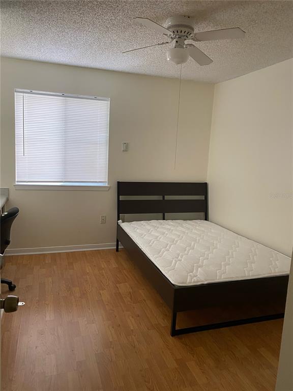 2601 Southwest Archer Road, Unit 321 Gainesville, FL 32608 - Photo 5 of 10 a room with a wooden table and chair