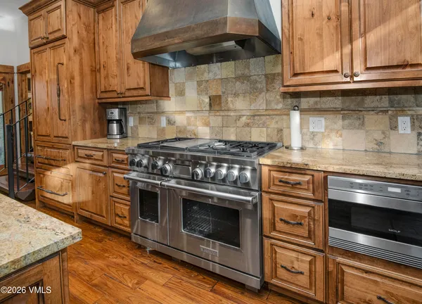 a stove top oven sitting inside of a kitchen