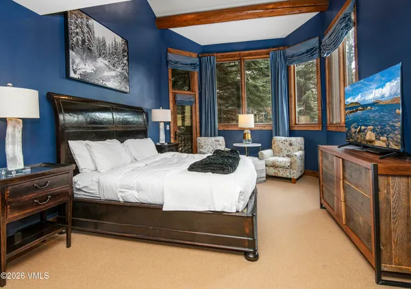 a bedroom with furniture and a large window