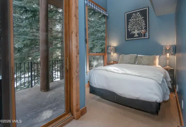 a bedroom with a bed lamp and window