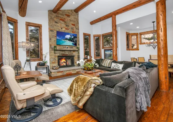 a living room with fireplace furniture and a large window
