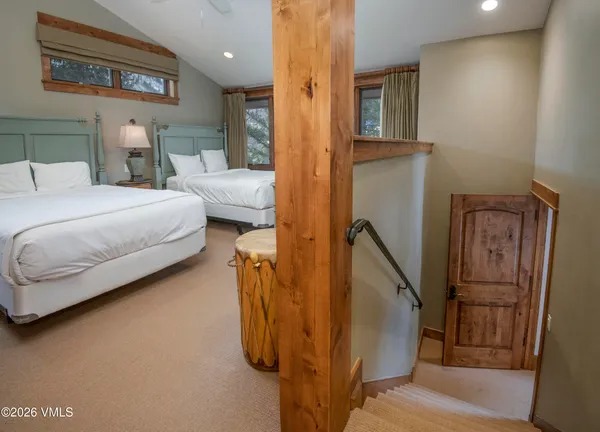 a bedroom with a bed and a refrigerator