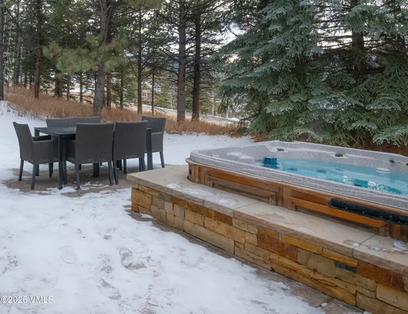 a view of backyard with table and chairs and couches