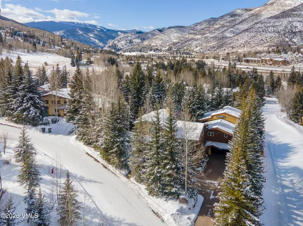 an aerial view of a house with a yard and lake view