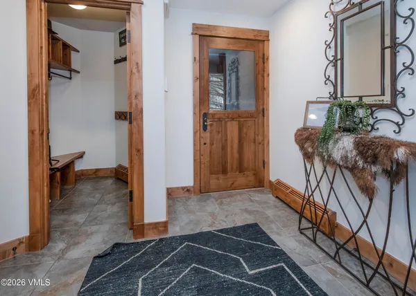a view of a hallway with wooden floor and a living room