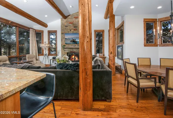 a kitchen with stainless steel appliances granite countertop sink table and chairs