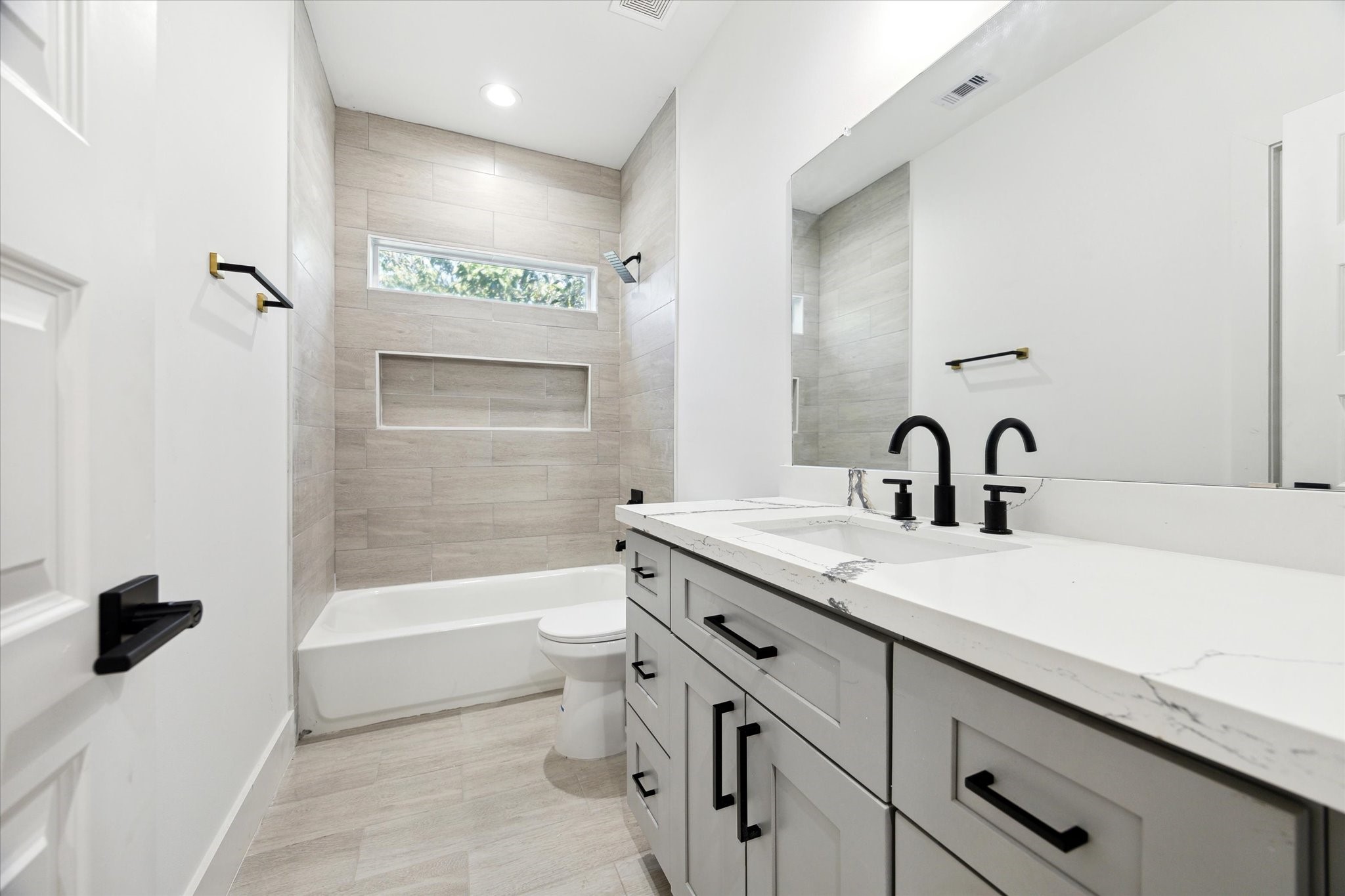 8012 Brandon Street Houston, TX 77051 - Photo 23 of 29 a bathroom with a granite countertop sink a toilet and bathtub