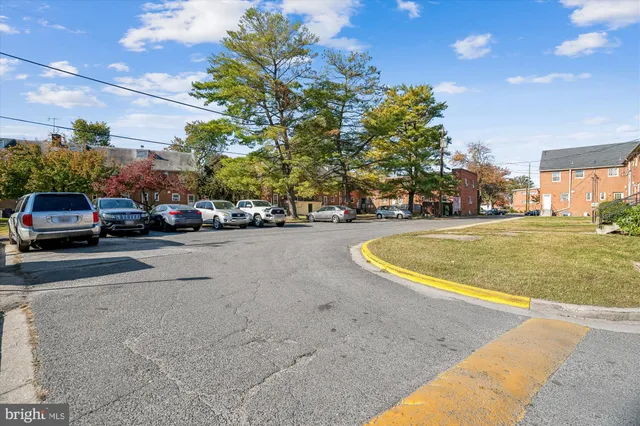a view of a cars park on the side of a road