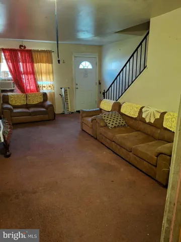 a living room with furniture and a lamp