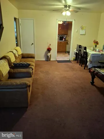 a living room with furniture and a mirror