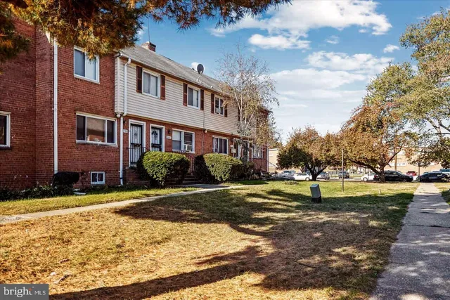 a view of big yard in front of a brick building