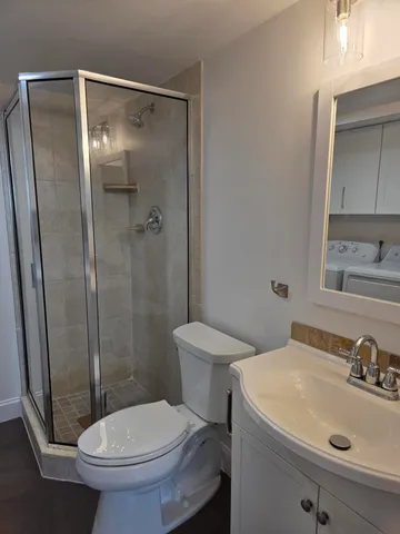 a bathroom with a sink toilet and shower