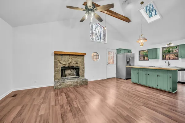 a view interior of a kitchen with a sink a kitchen a fireplace and wooden floor