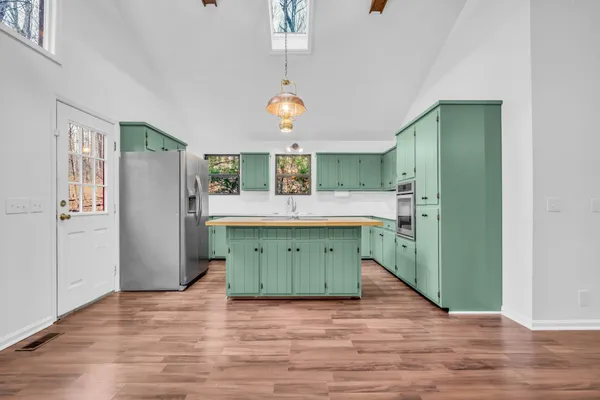 a kitchen with a refrigerator and a sink