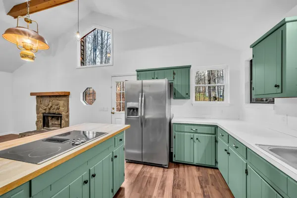 a kitchen with stainless steel appliances granite countertop a sink refrigerator and microwave