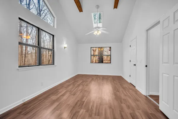 wooden floor in an empty room with a window