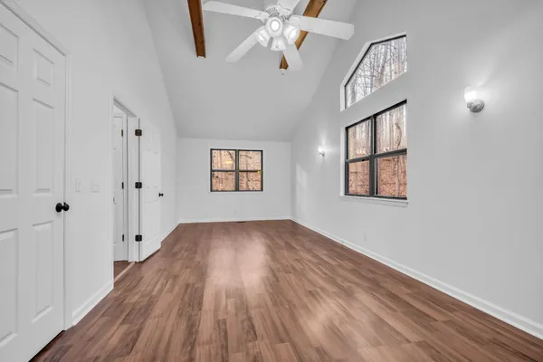 wooden floor in an empty room with a window
