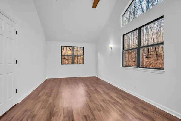 wooden floor in an empty room with a window