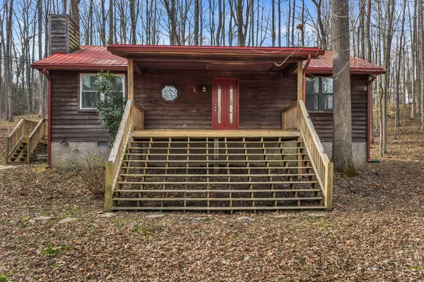 a front view of a house with plants