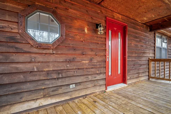 a view of a wooden door with brick walls