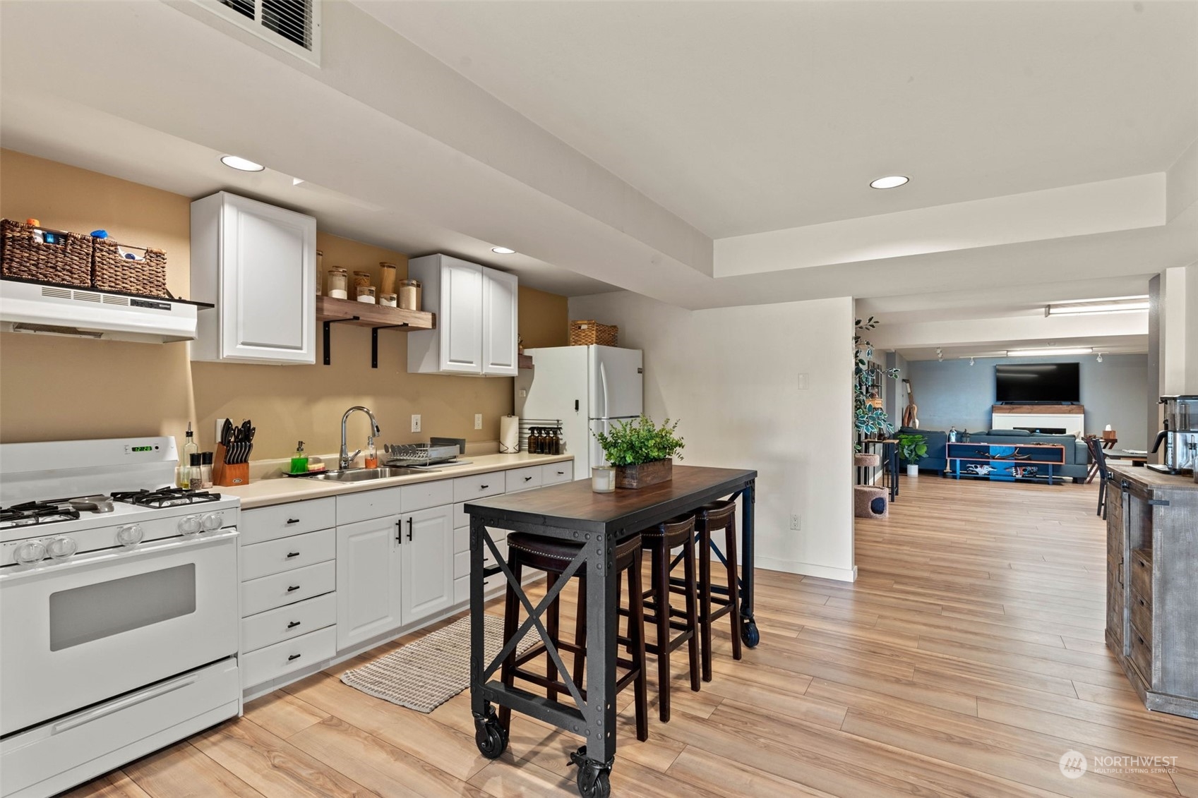 4209 South Eastern Road Spokane, WA 99223 - Photo 30 of 40 a kitchen with stainless steel appliances a table and chairs in it