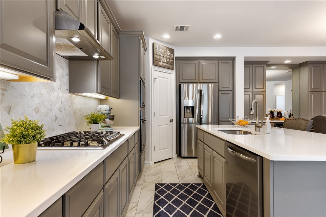 348 Fort Cobb Way Georgetown, TX 78628 - Photo 1 of 1 a kitchen with a sink and refrigerator