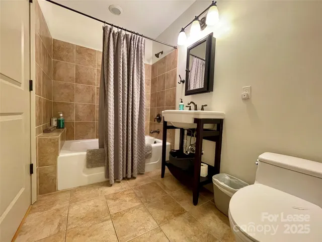 a bathroom with a toilet a sink and bathtub