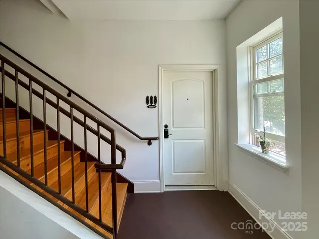 a view of an entryway with wooden floor