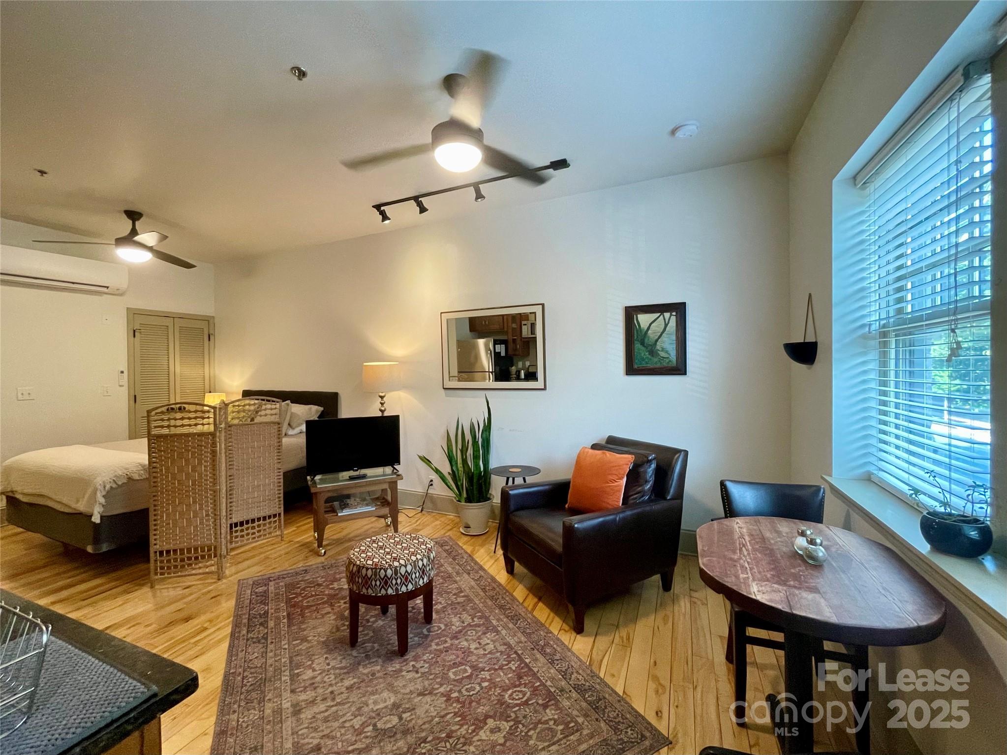 5 West Walnut Street, Unit 202 Asheville, NC 28801 - Photo 5 of 14 a living room with furniture and a window