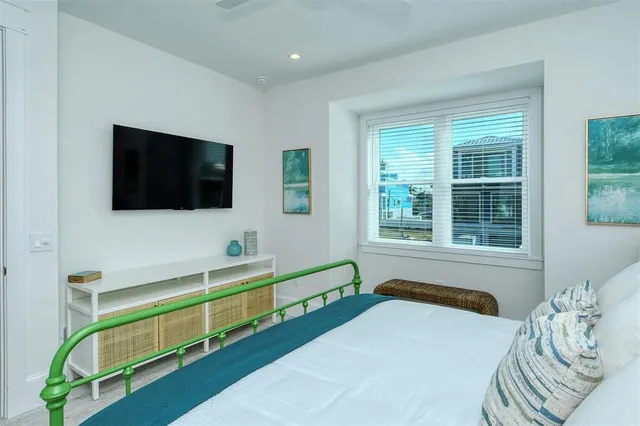 a bedroom with a large bed and a window