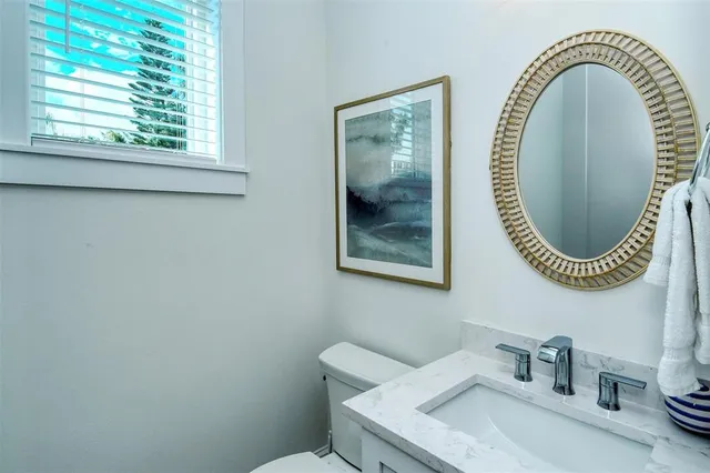 a living room with furniture a flat screen tv and a window