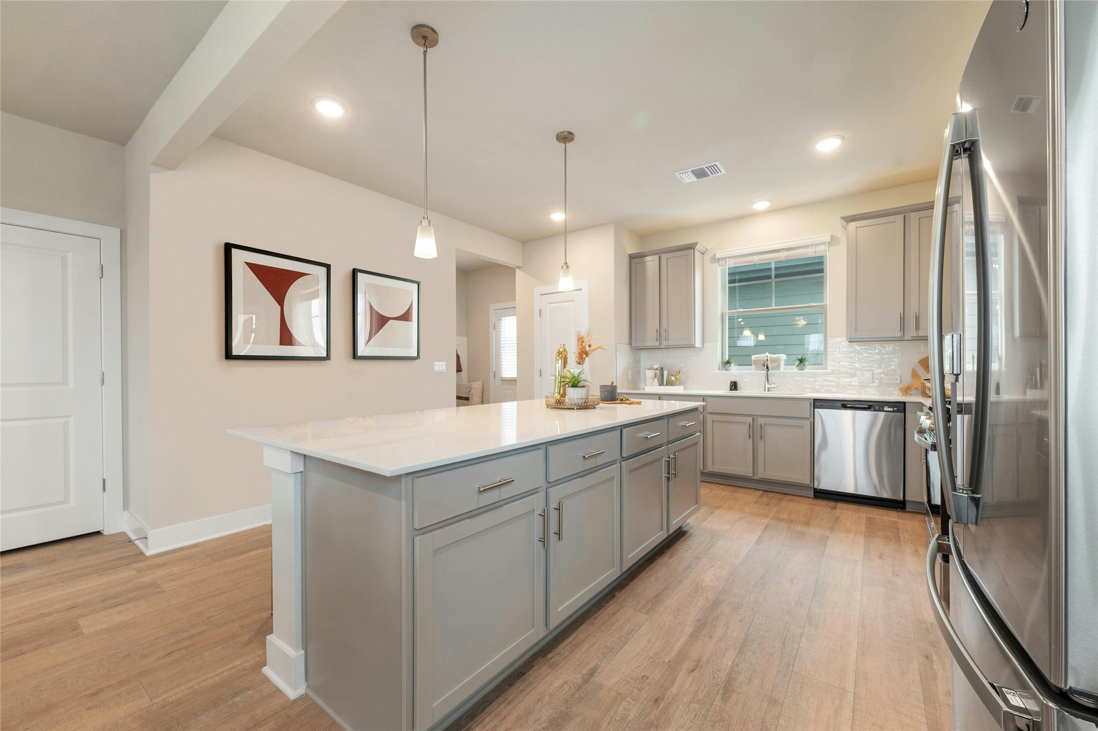 5804 Rotunda View Austin, TX 78747 - Photo 10 of 27 A well-lit kitchen with a central island and contemporary light gray cabinetry.