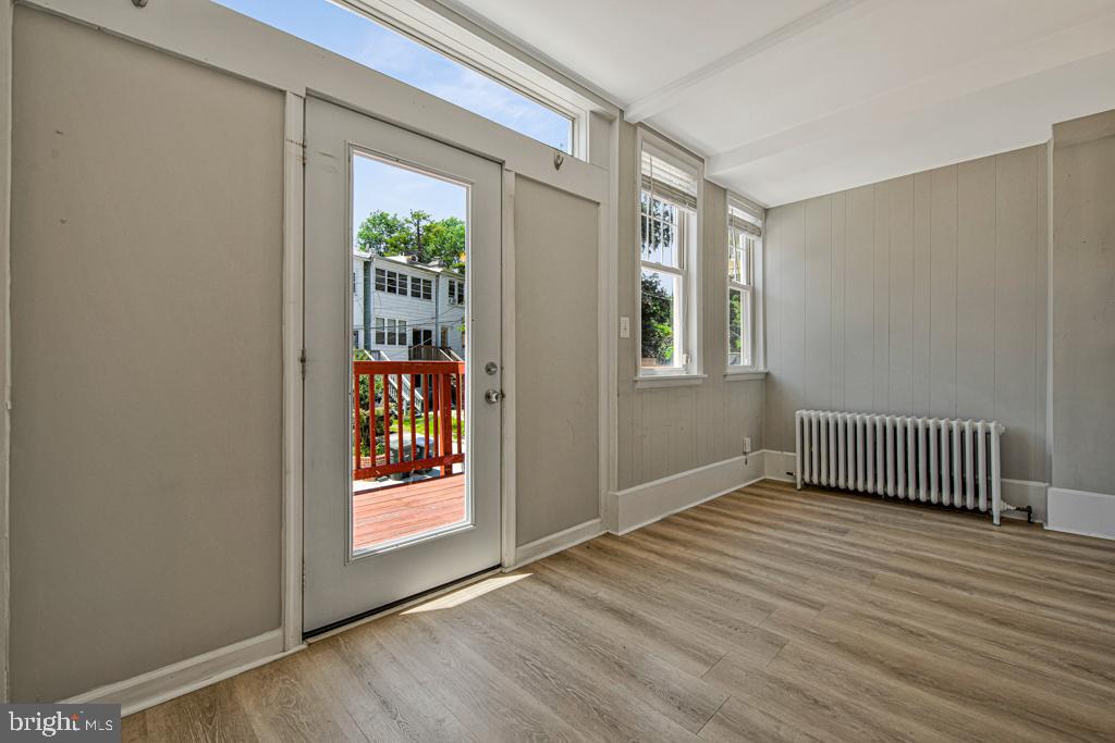 2406 37th Street Northwest Washington, DC 20007 - Photo 22 of 44 an empty room with wooden floor and windows