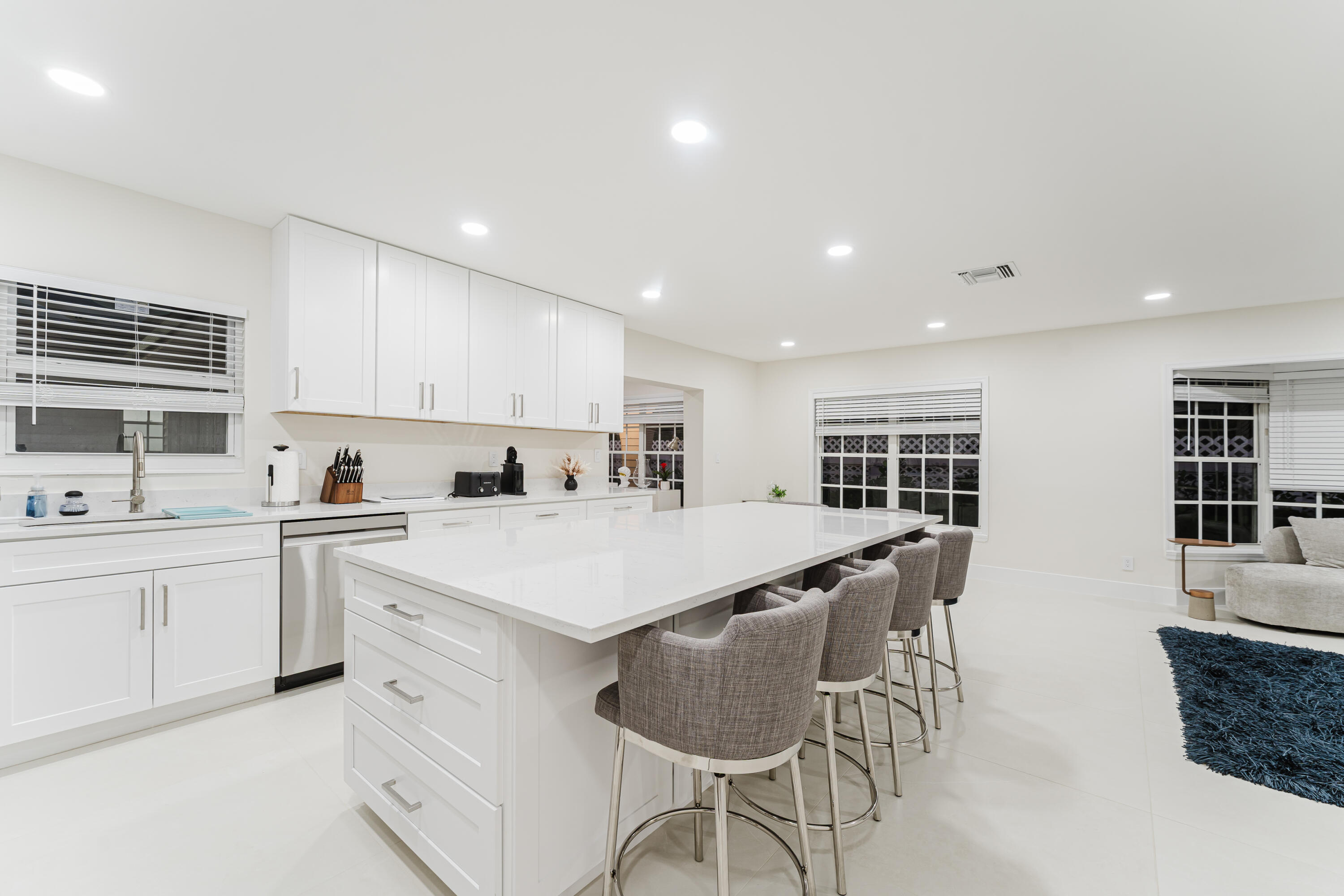 3199 Northeast 6th Drive Boca Raton, FL 33431 - Photo 22 of 49 a large white kitchen with cabinets
