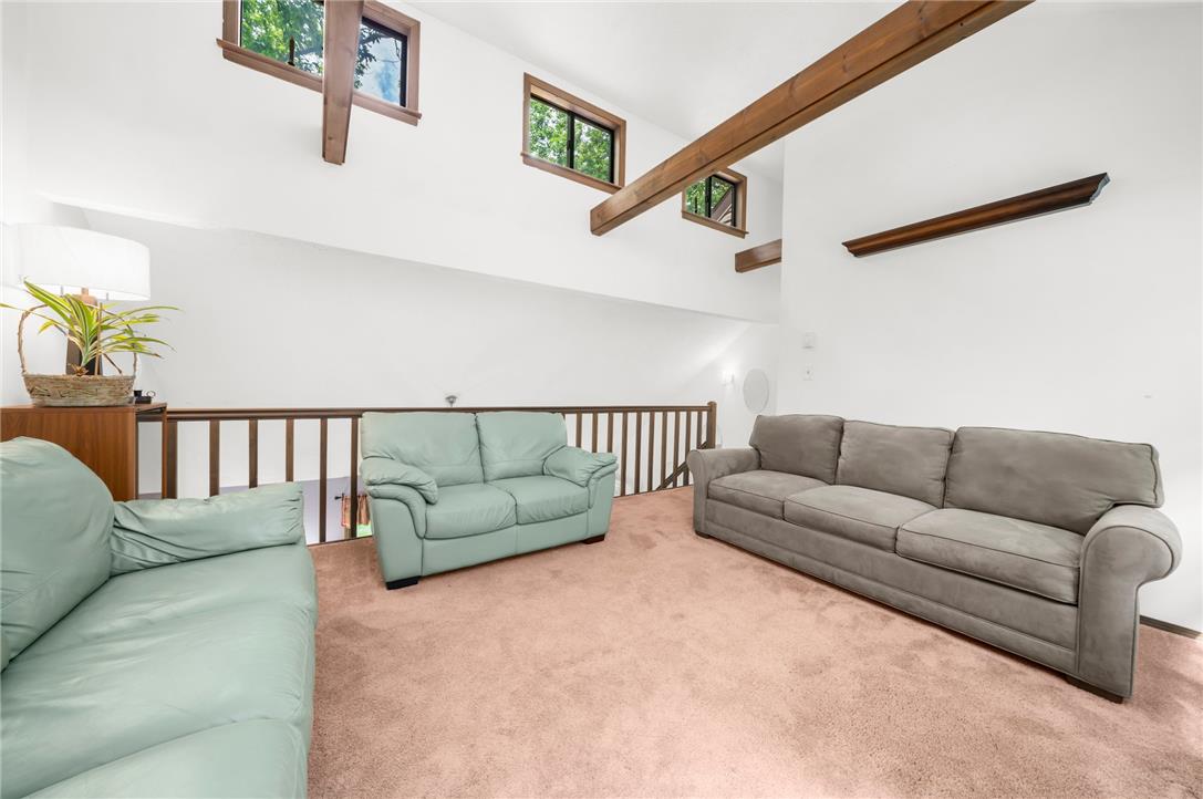 222 Powder Horn Road Henryville, PA 18332 - Photo 11 of 25 Tall ceilings and exposed wooden beams characterize this bright, upper-level gathering area.