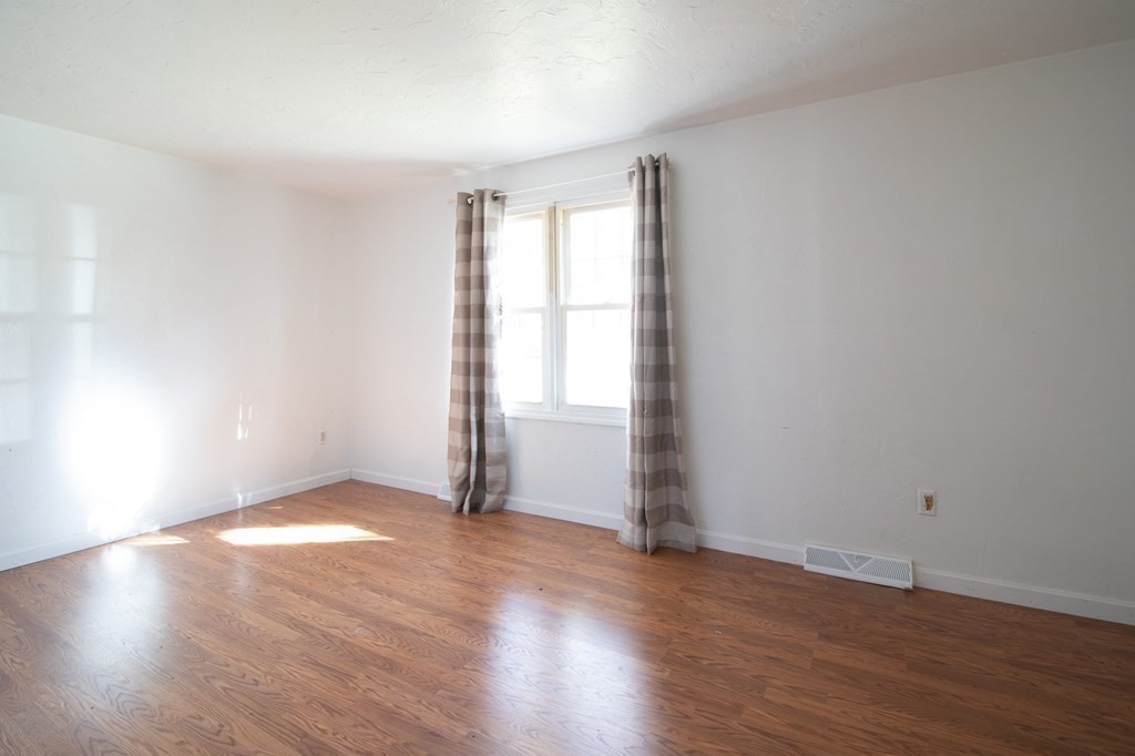 521 Lincoln Rd Extension Hyannis, MA 02601 - Photo 7 of 17 an empty room with wooden floor and windows