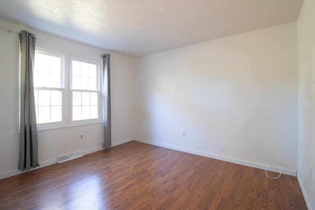 521 Lincoln Rd Extension Hyannis, MA 02601 - Photo 9 of 17 wooden floor in an empty room with a window