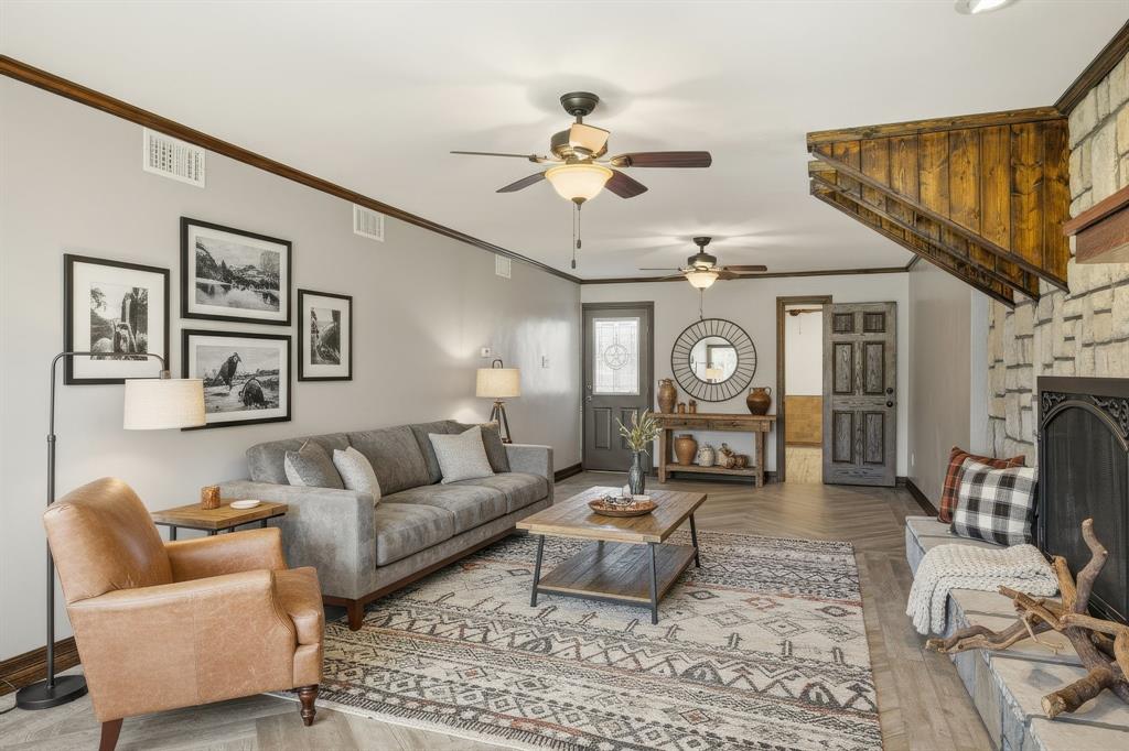424 Edwards Drive Dublin, TX 76446 - Photo 12 of 40 a living room with furniture a fireplace and a chandelier