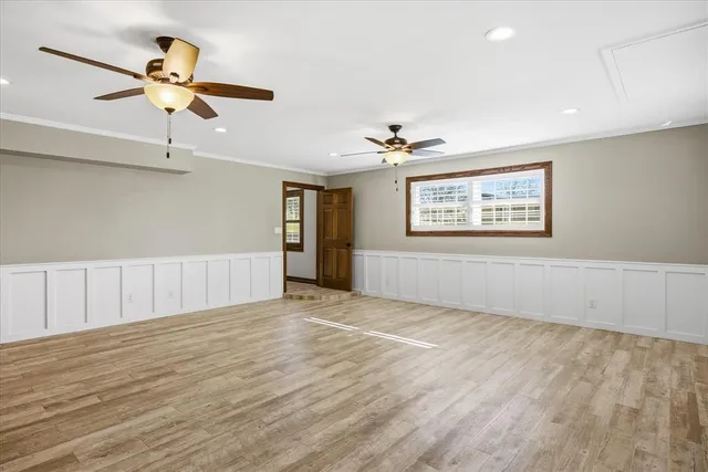 a view of an empty room with wooden floor