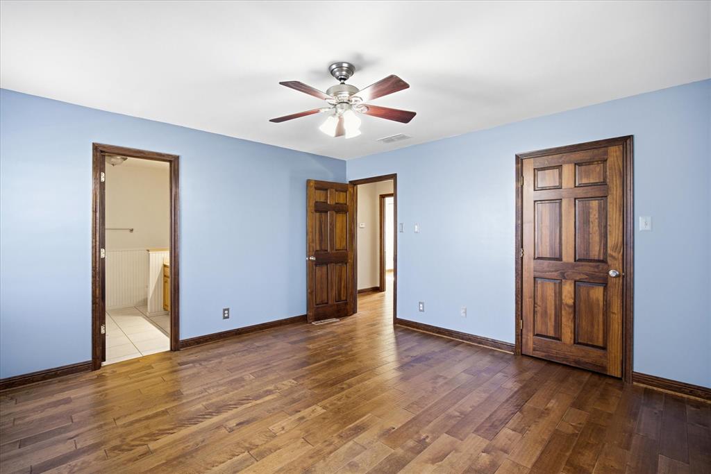 424 Edwards Drive Dublin, TX 76446 - Photo 23 of 40 a view of an empty room with wooden floor