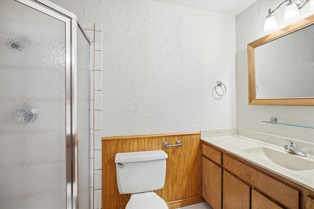 424 Edwards Drive Dublin, TX 76446 - Photo 24 of 40 a bathroom with a sink mirror vanity and toilet