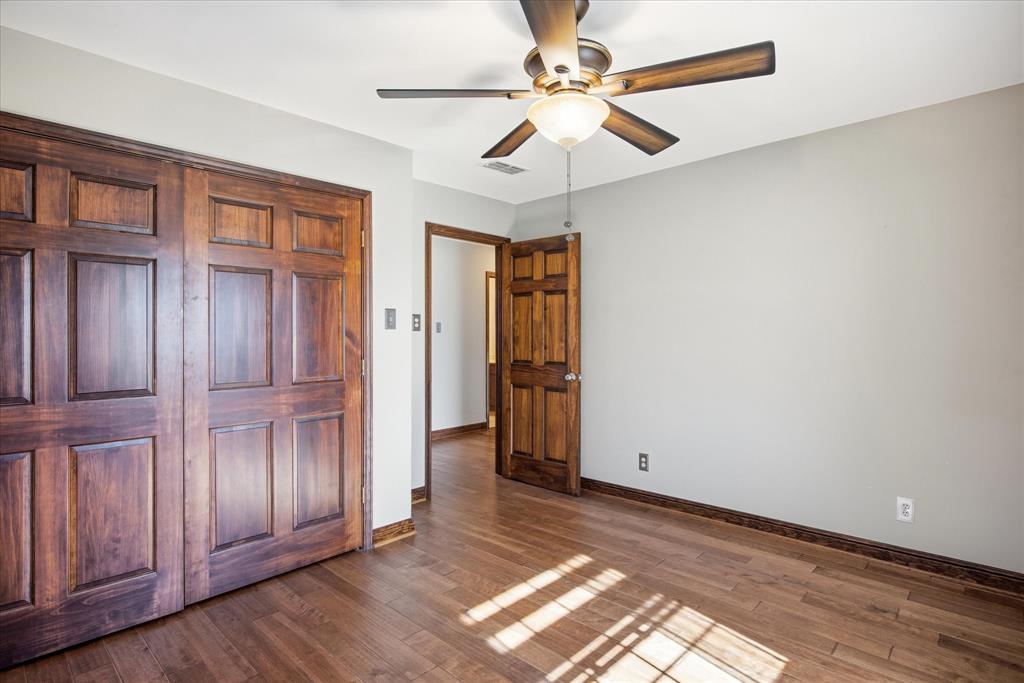 424 Edwards Drive Dublin, TX 76446 - Photo 26 of 40 an empty room with wooden floor fan and windows