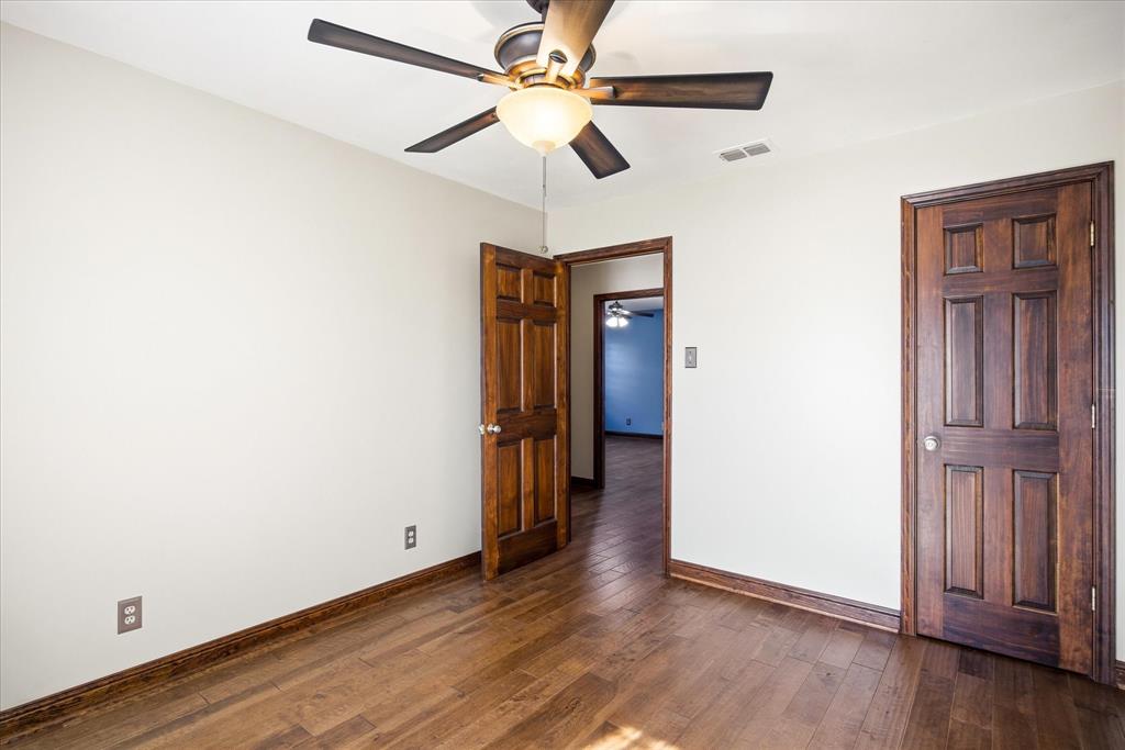 424 Edwards Drive Dublin, TX 76446 - Photo 27 of 40 a view of an empty room with wooden floor