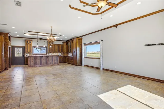 a living room with furniture a flat screen tv and a chandelier