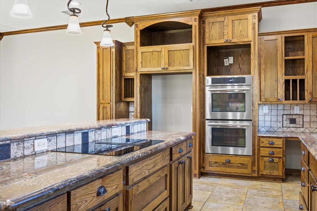424 Edwards Drive Dublin, TX 76446 - Photo 9 of 40 a kitchen with stainless steel appliances granite countertop a sink and cabinets