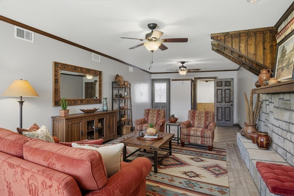 424 Edwards Drive Dublin, TX 76446 - Photo 10 of 40 a living room with furniture a fireplace and a flat screen tv