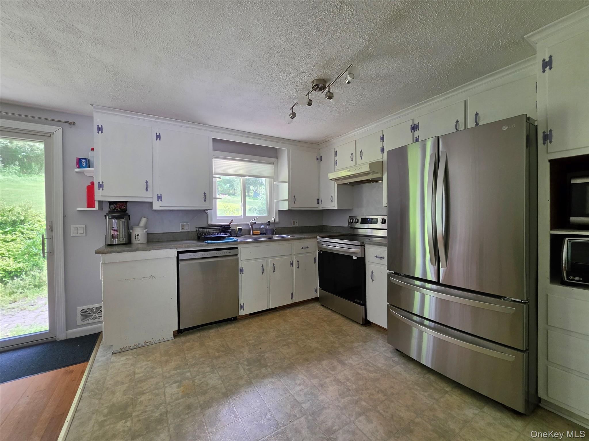 4804 Country Club Road Vestal, NY 13850 - Photo 4 of 15 a kitchen with a refrigerator sink and cabinets