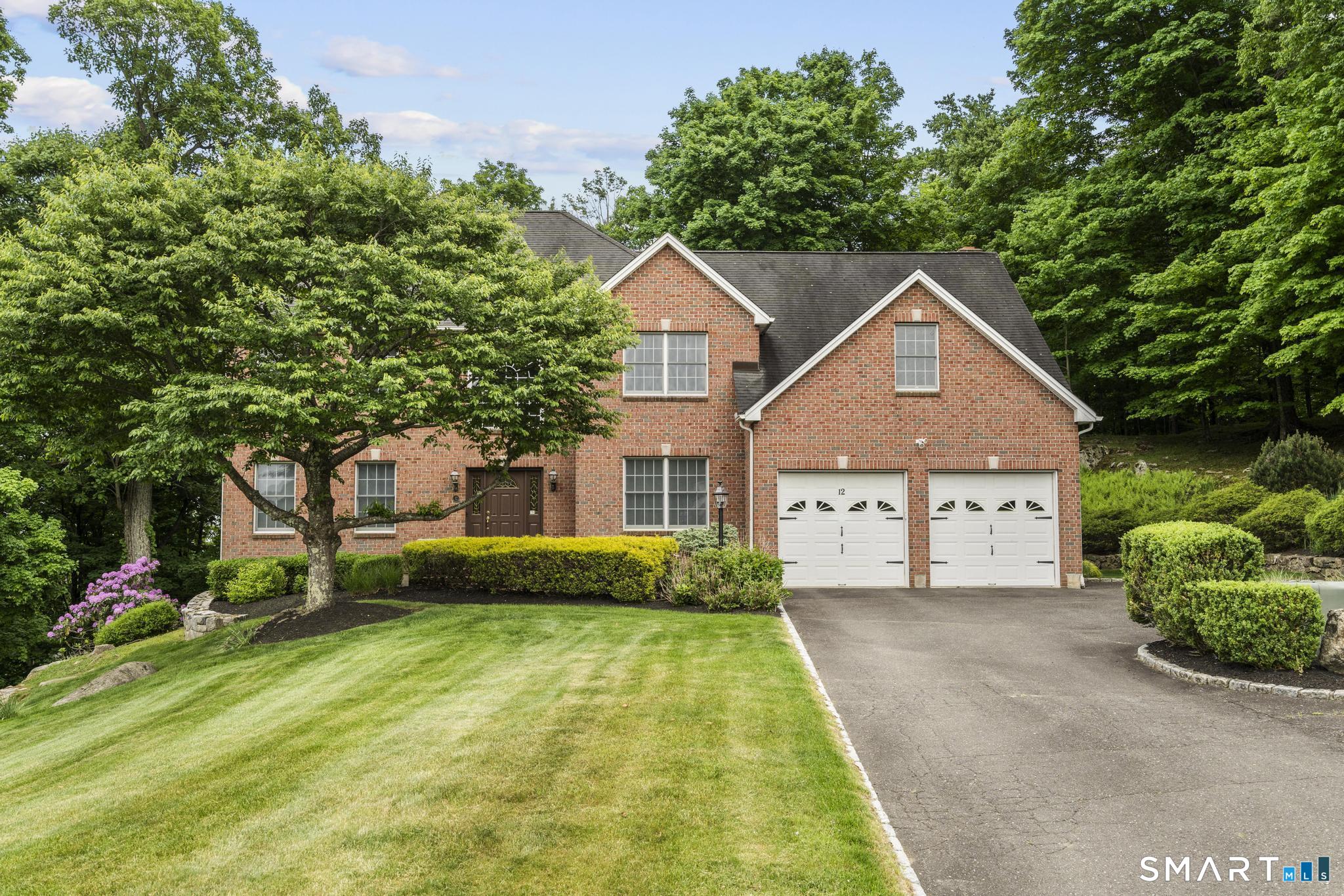 12 Logans Way Danbury, CT 06811 - Photo 1 of 40 a front view of a house with garden