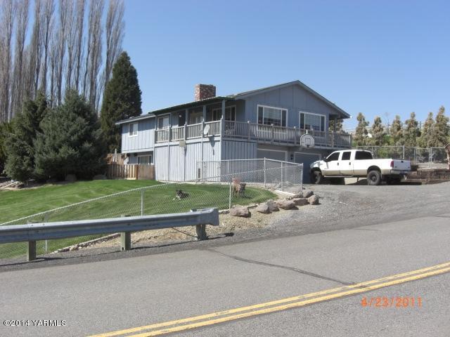 a front view of a house with a garden and parking space