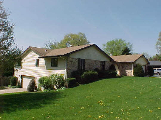 4613 Sunderman Road Rockford, IL 61114 - Photo 3 of 6 a front view of a house with a yard and garage